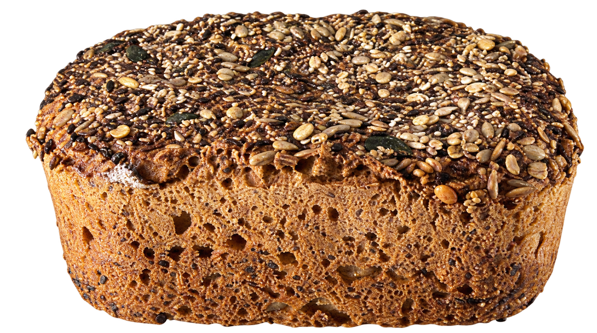 A rustic whole grain Barley bread loaf topped with a dense mixture of seeds, nuts, and dried herbs.